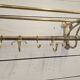 Wall-mounted coat rack with brass hat rack