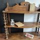 Antique wall shelf made of turned wood and spools of thread, late 19th century.
