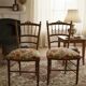Two floral upholstered music chairs from the early 20th century.