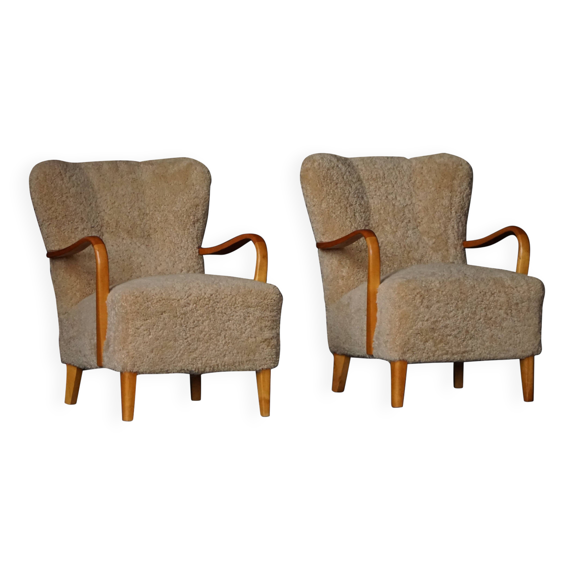 Pair of Mid Century Modern Swedish lounge chairs in birch and lamb's wool, 1960s.