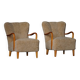 Pair of Mid Century Modern Swedish lounge chairs in birch and lamb's wool, 1960s.