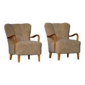 Pair of Mid Century Modern Swedish lounge chairs in birch and lamb's wool, 1960s.