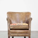 Fauteuil en cuir subtil avec coussin d'assise réversible en kilim