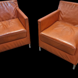 Pair of vintage orange leather armchairs