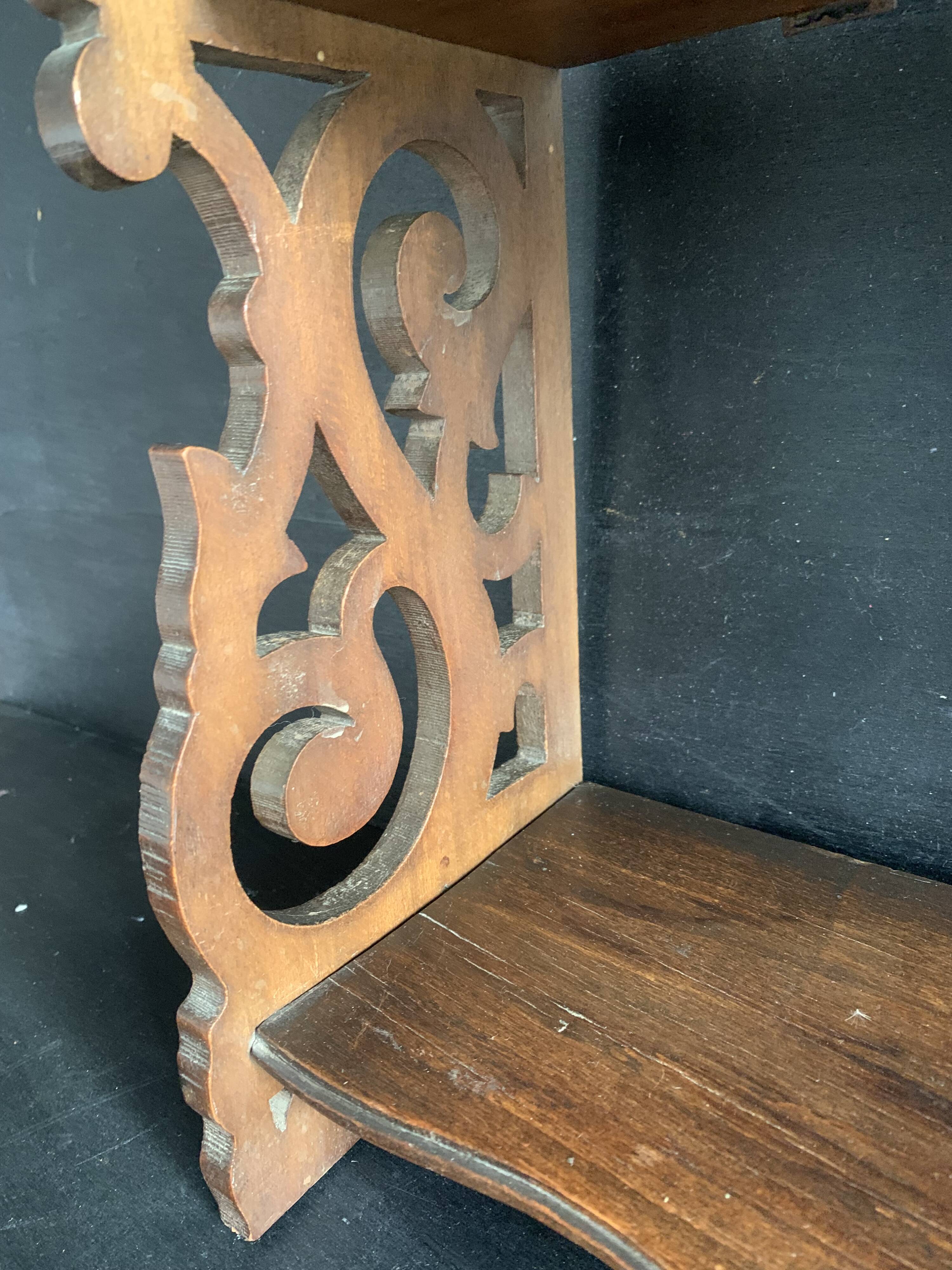 Antique shelf with openwork wooden pediment, early 20th century
