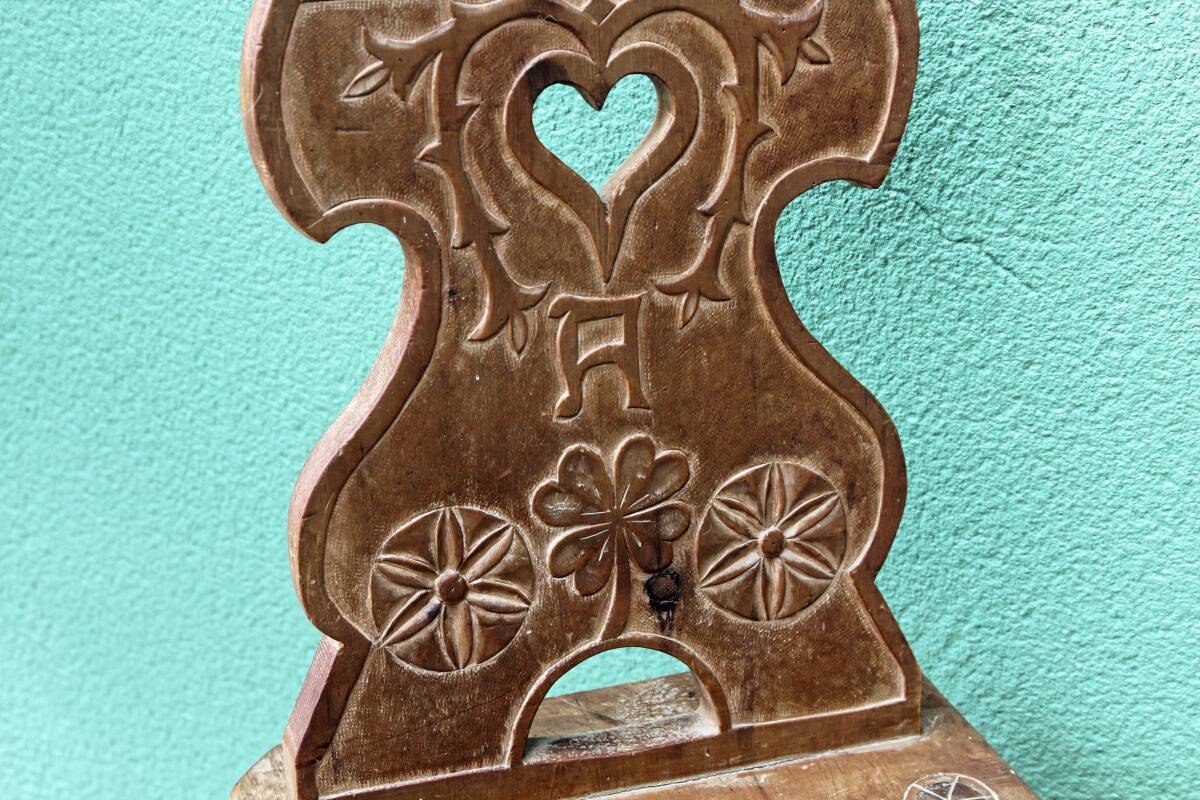 Old Swiss escabelle chair in carved wood