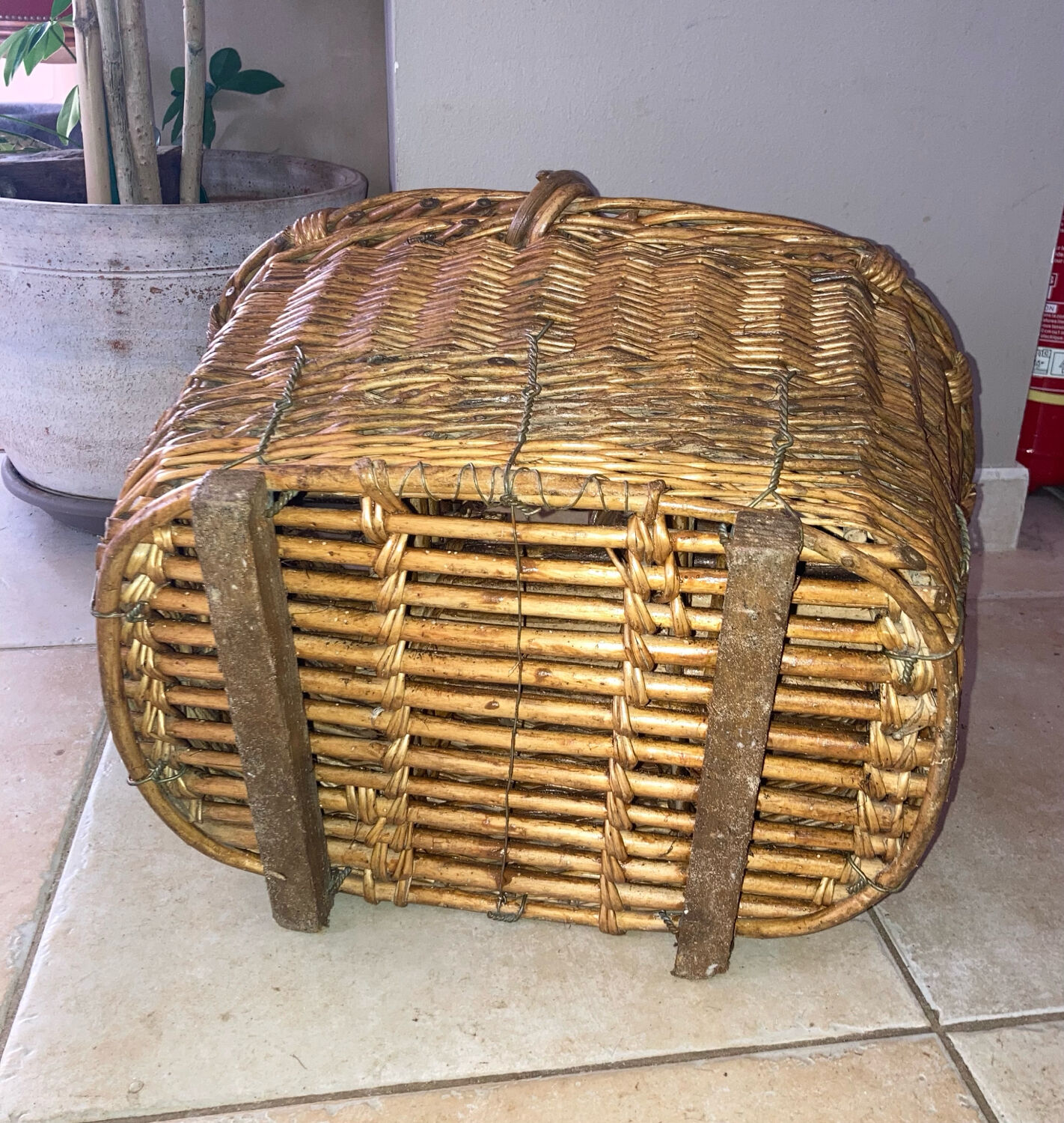 Wicker and hazel bottle basket from the early 20th century or possibly earlier.
