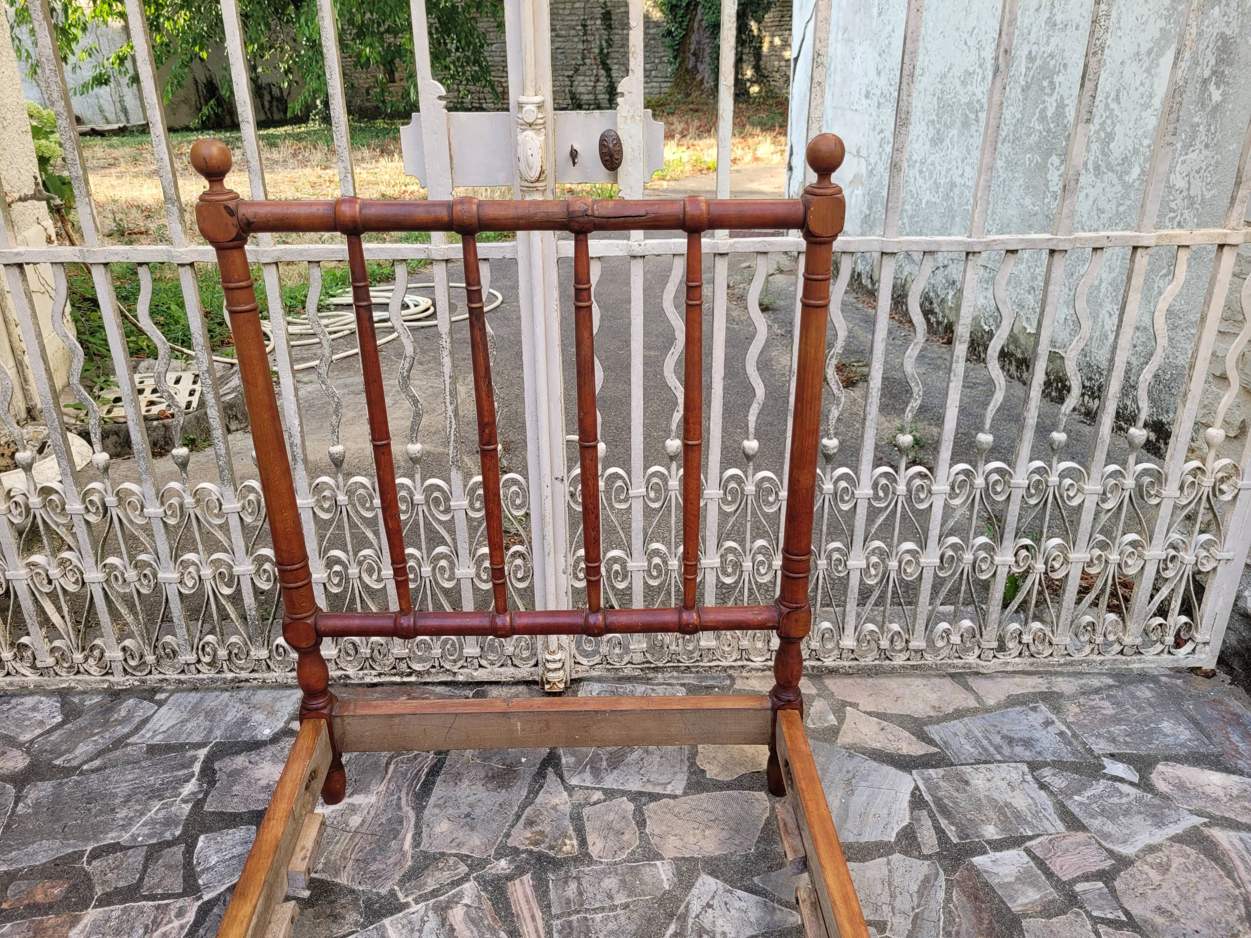 Child's bed or vintage rest bed made of solid cherry wood in a bamboo style.