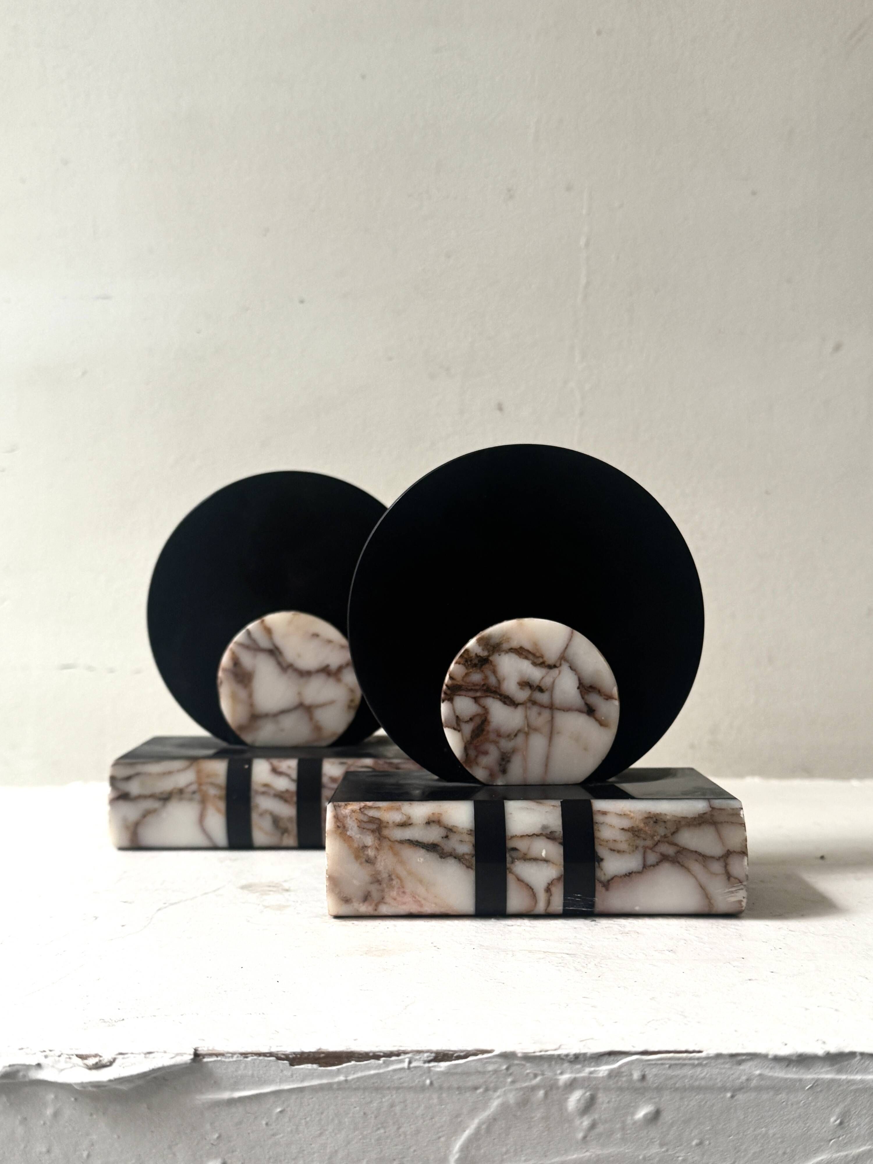 Art Deco bookends with a circular design in black and pink marble.