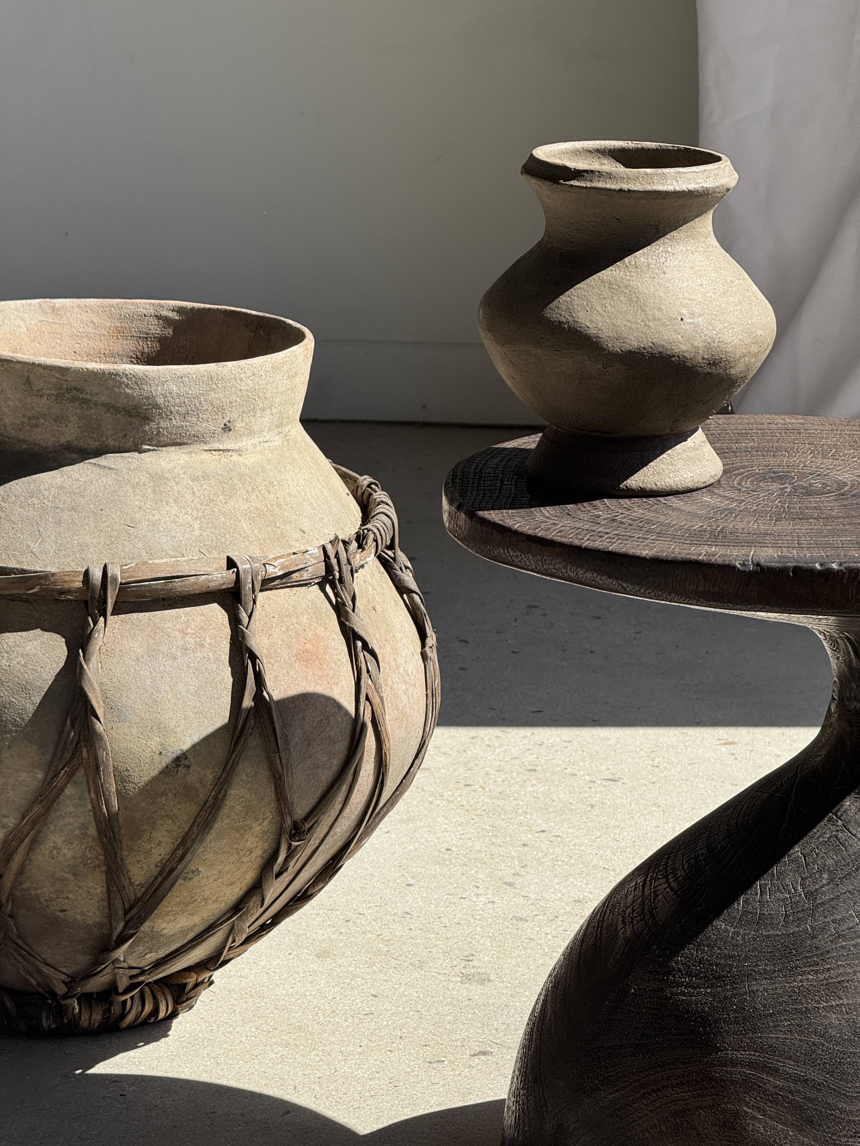 Small brutalist handcrafted terracotta vase with a pedestal, Indonesian, H19 D17.