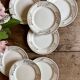 Set of 8 vintage white and gold dessert plates.