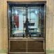 Early 20th-century shop display cabinet in oak with sliding doors.