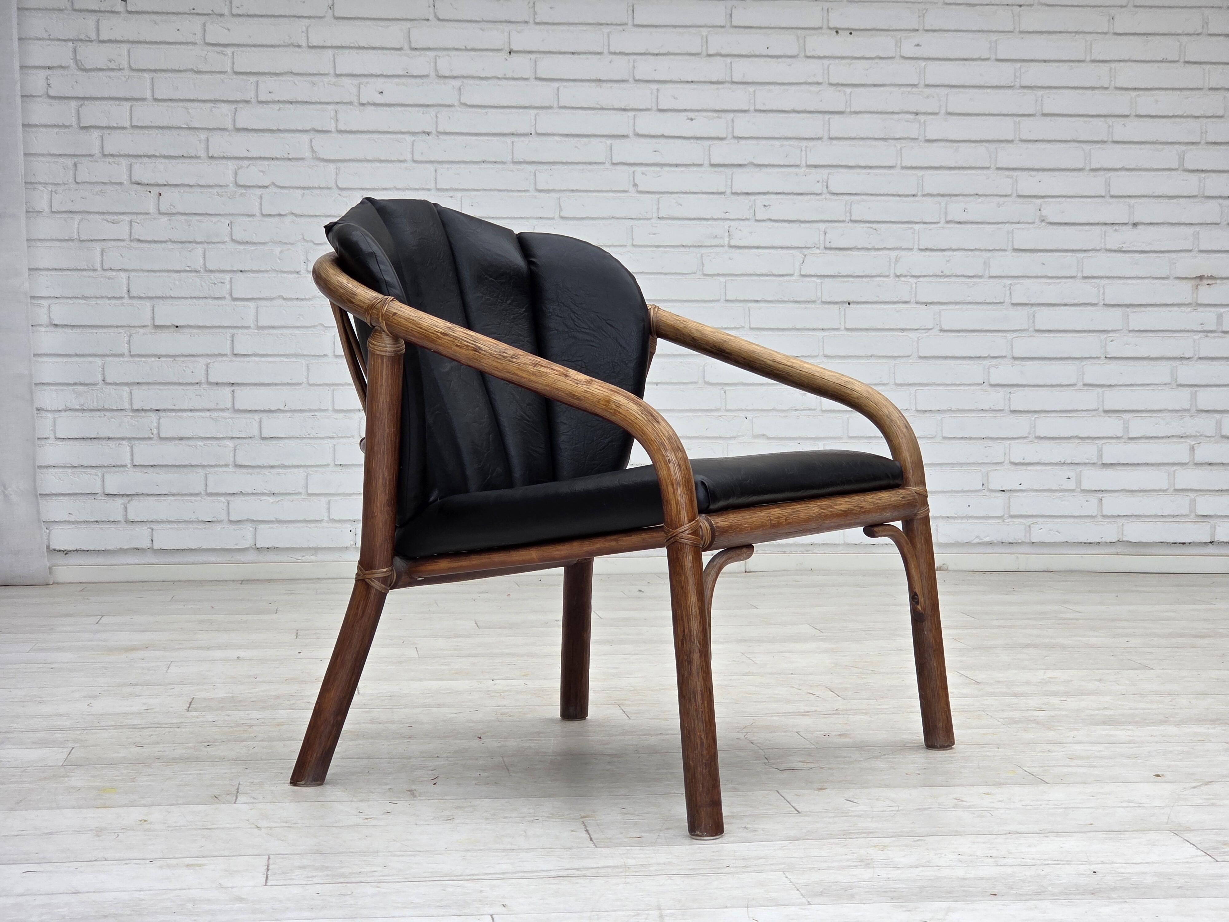 1970s, Danish armchair, rattan, black artificial leather.