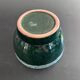 Green cache pot with a foam trim.