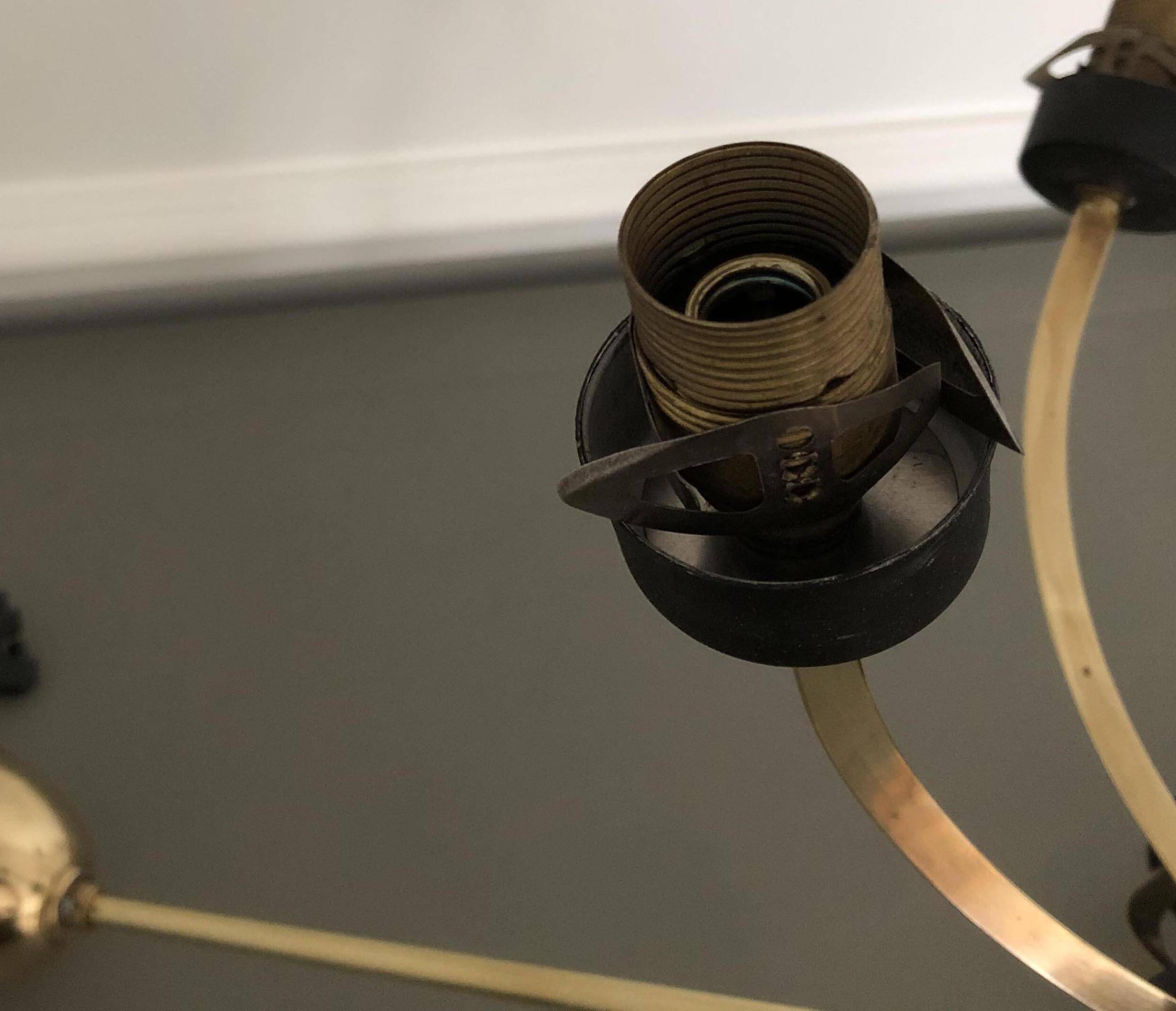 Lustre with 5 branches from the 1960s - 1970s in solid brass and black metal.