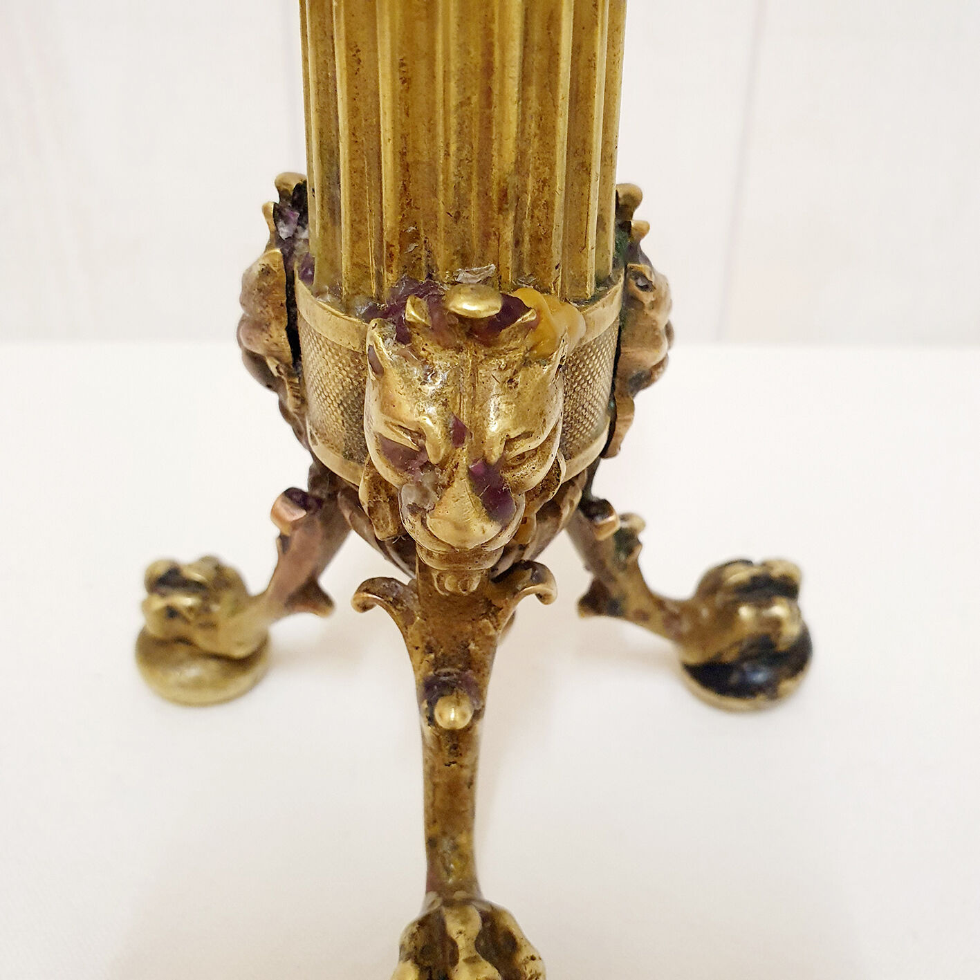Golden candle holder with lion's head and legs