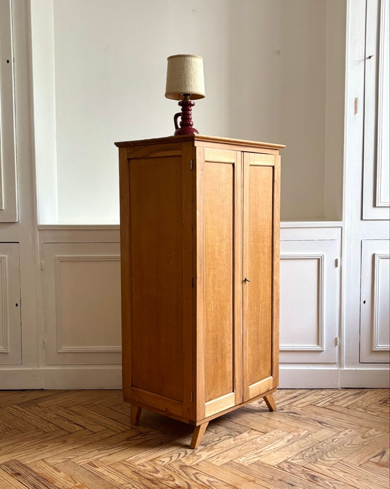 Small oak cabinet with tapered legs.