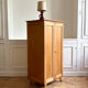 Small oak cabinet with tapered legs.