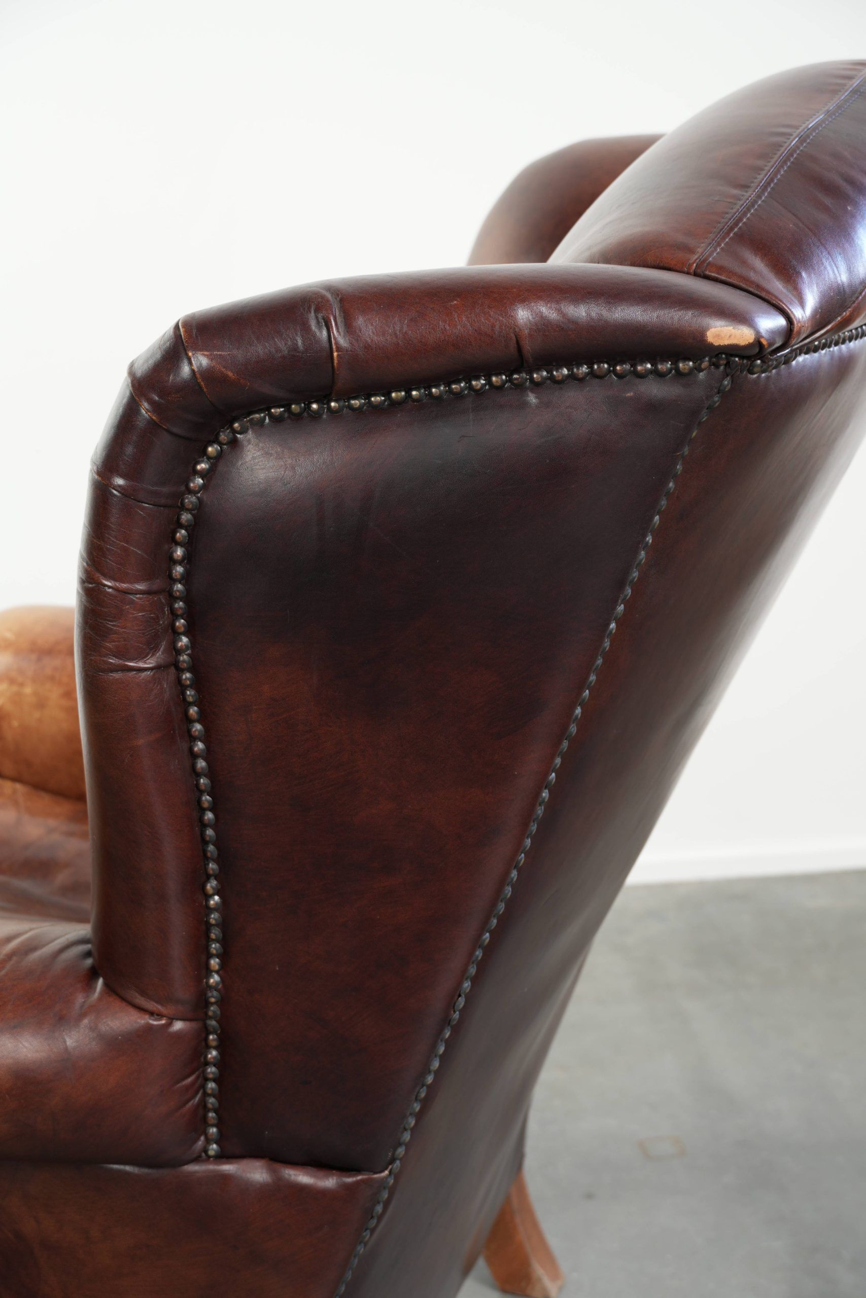 Comfortable cowhide wingback armchair in English style