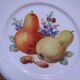 Set of 7 dessert plates and a cake stand with fruit patterns.