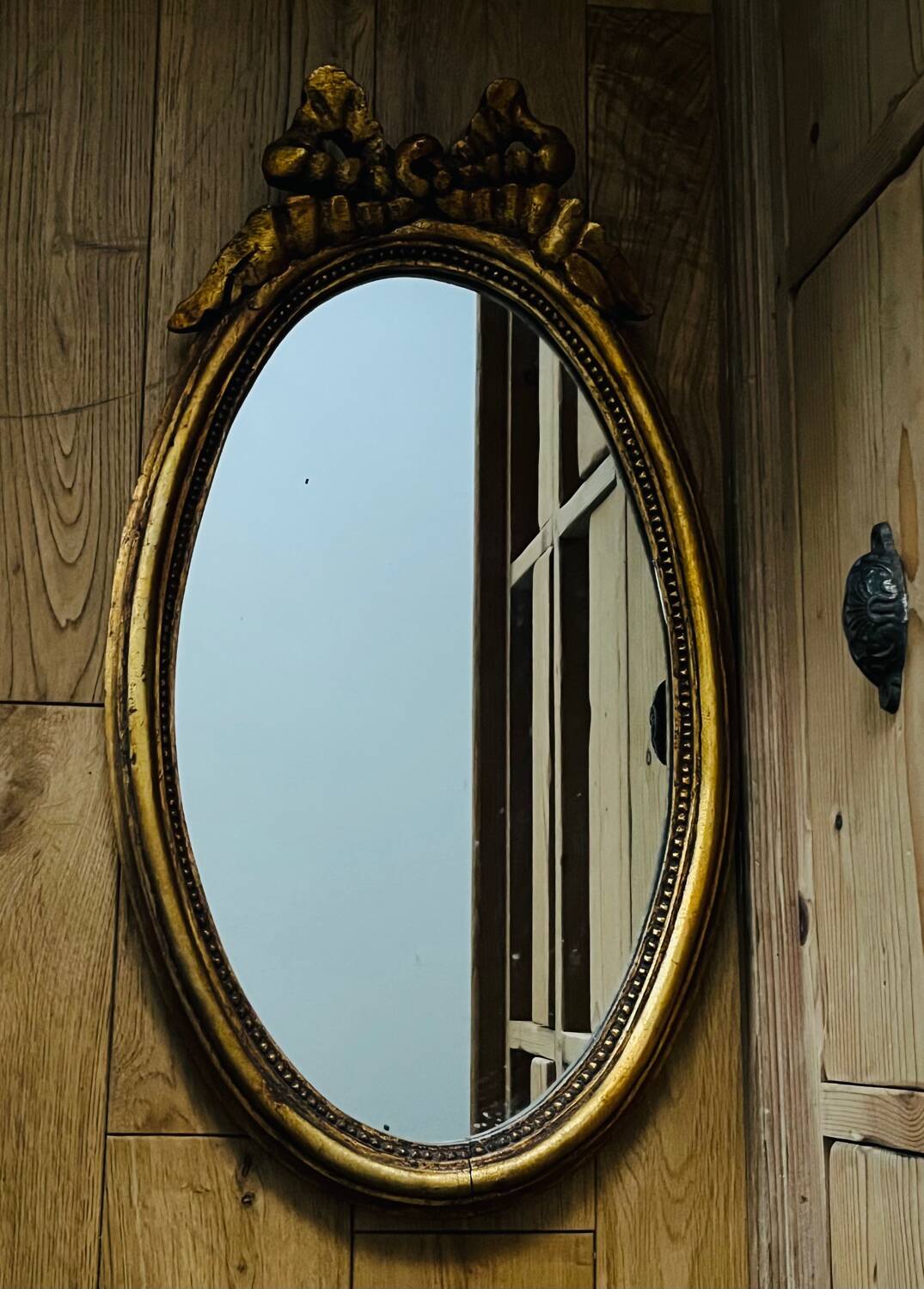 Old oval gilded stucco mirror