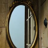Old oval gilded stucco mirror