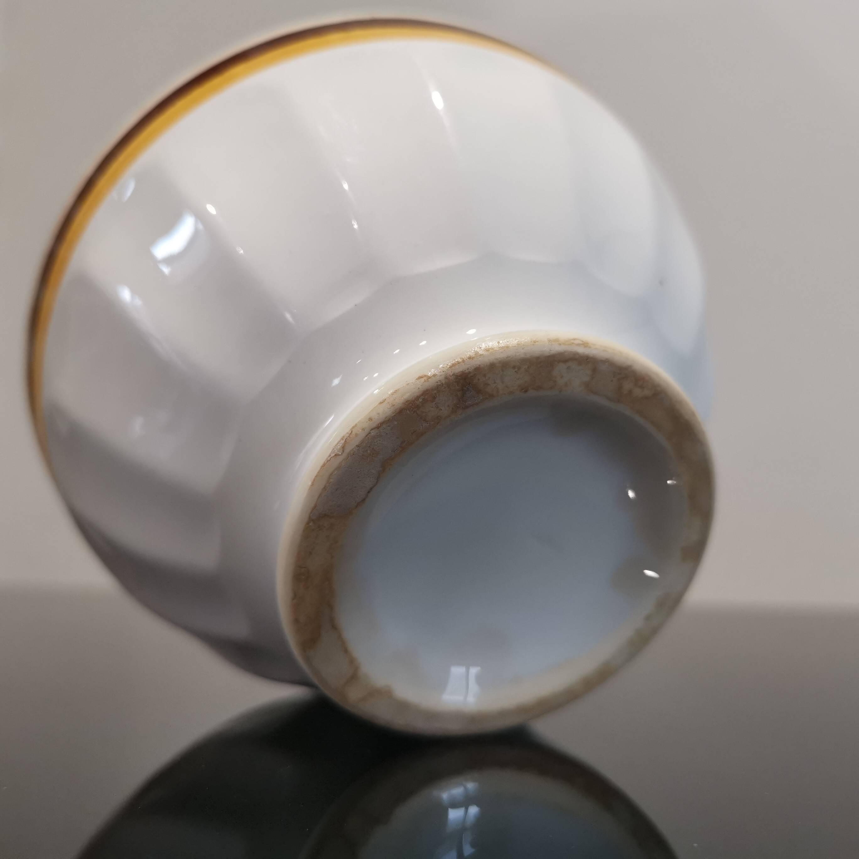 Authentic Vintage ceramic faceted bowl decorated with a double border