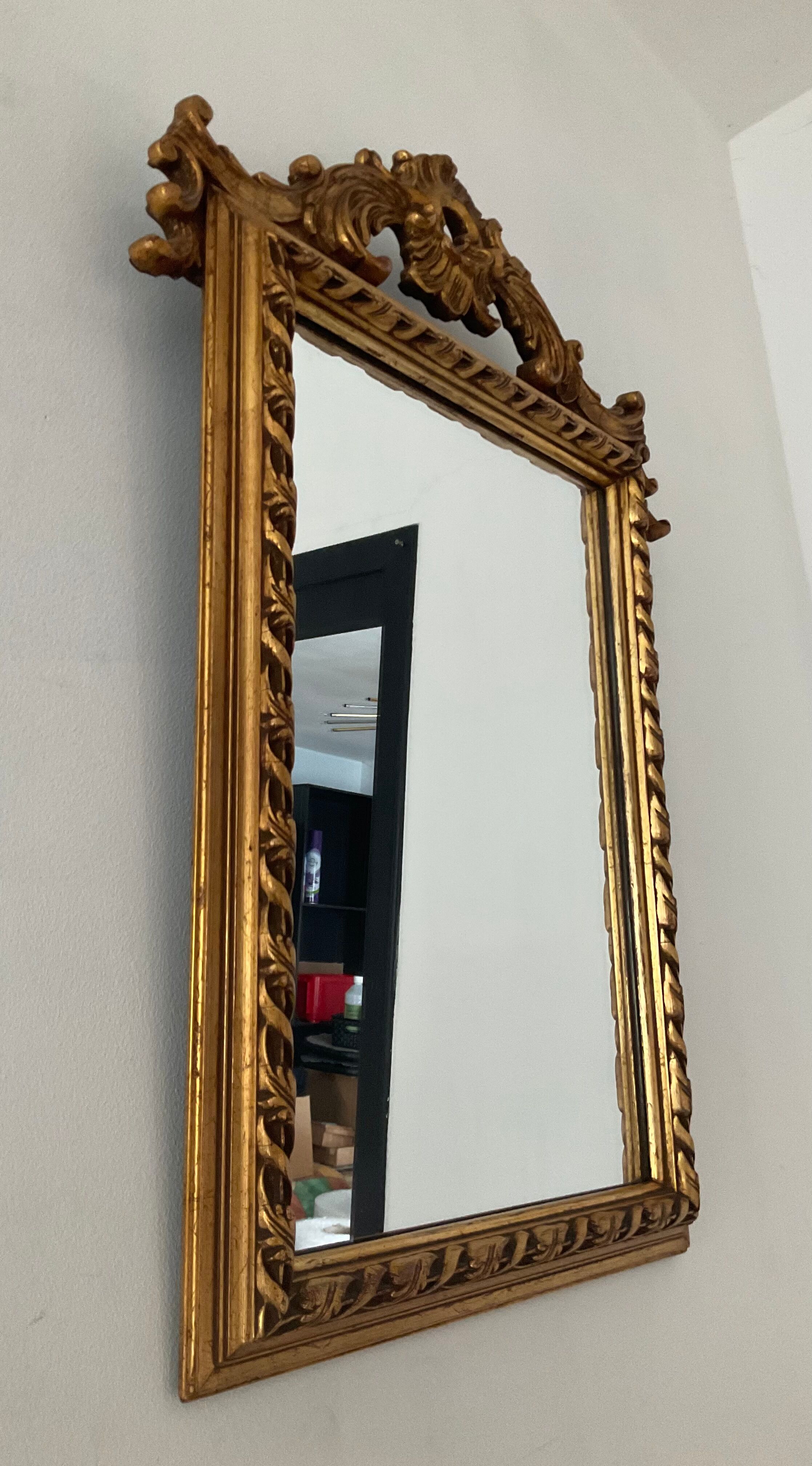 Old pedimented mirror in gilded wood
