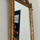 Old pedimented mirror in gilded wood