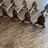 Series of 12 monogrammed silver metal knife holders