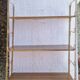 Wall shelf in metal with slanted shelves