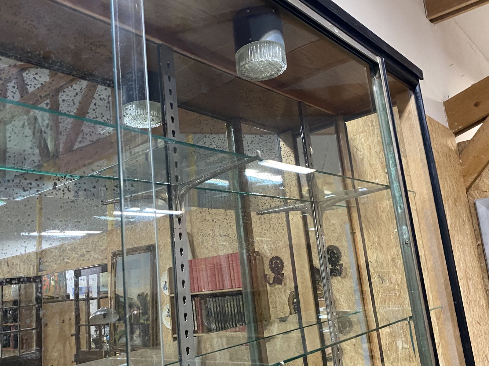 Store window with sliding doors in matte black patinated oak - 30s
