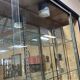 Store window with sliding doors in matte black patinated oak - 30s