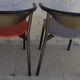 4 Gondola-style chairs with a sturdy metal frame and faux leather for