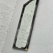 Mirror in black metal and brass with gunmetal finish