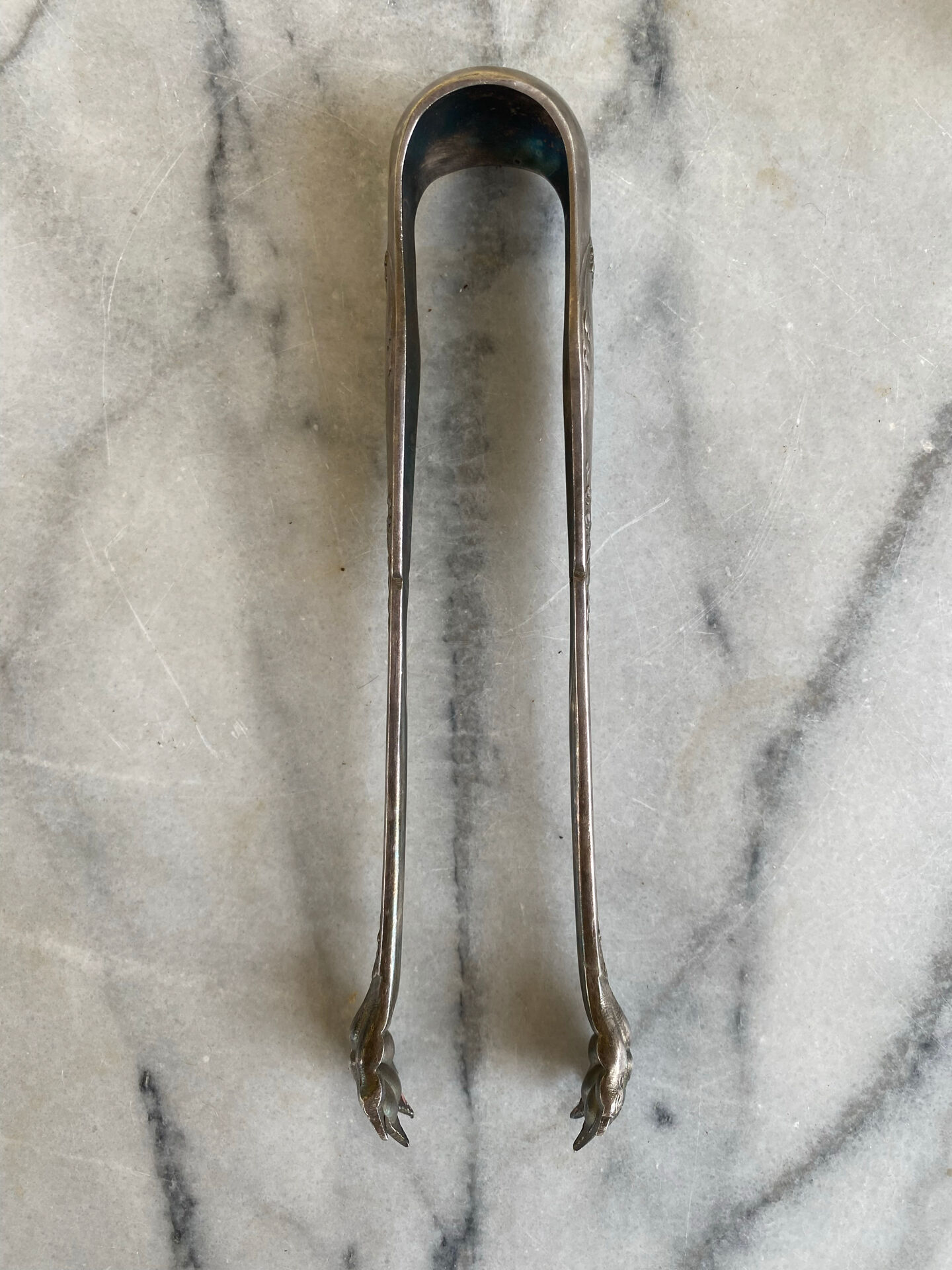 Antique silver-plated sugar tongs SFAM with monogram.