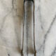 Antique silver-plated sugar tongs SFAM with monogram.