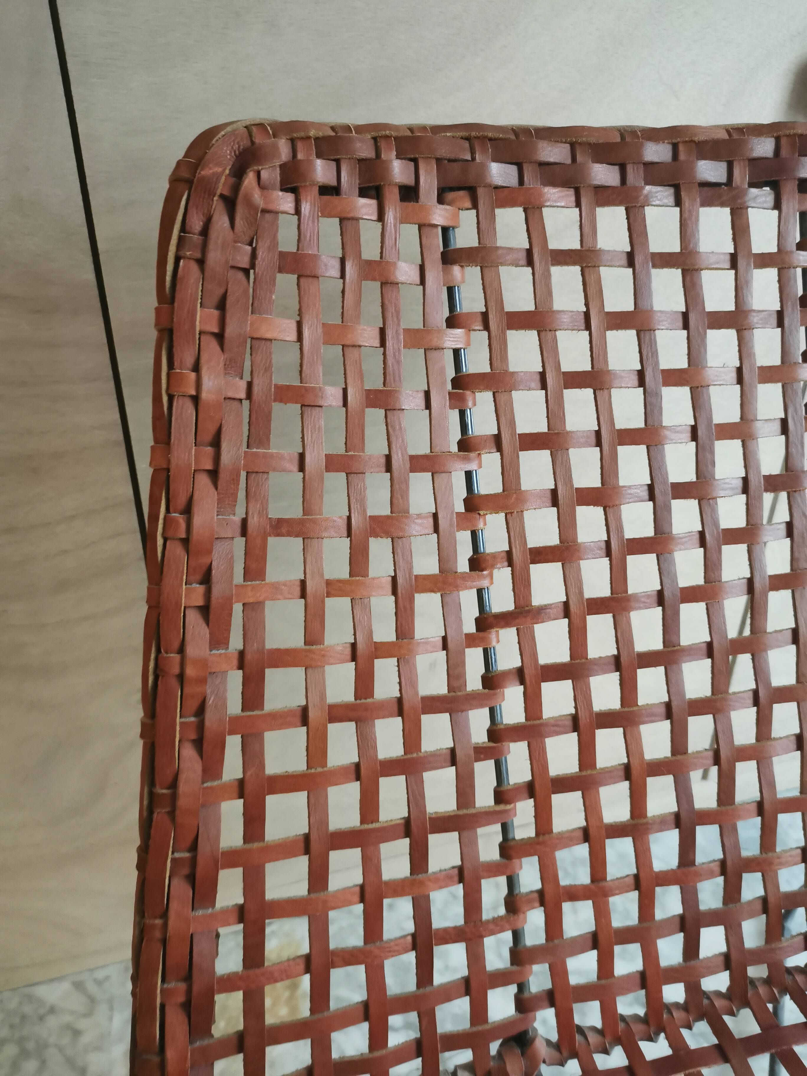 Modernist armchair in woven leather and black metal – 1960s–1970s