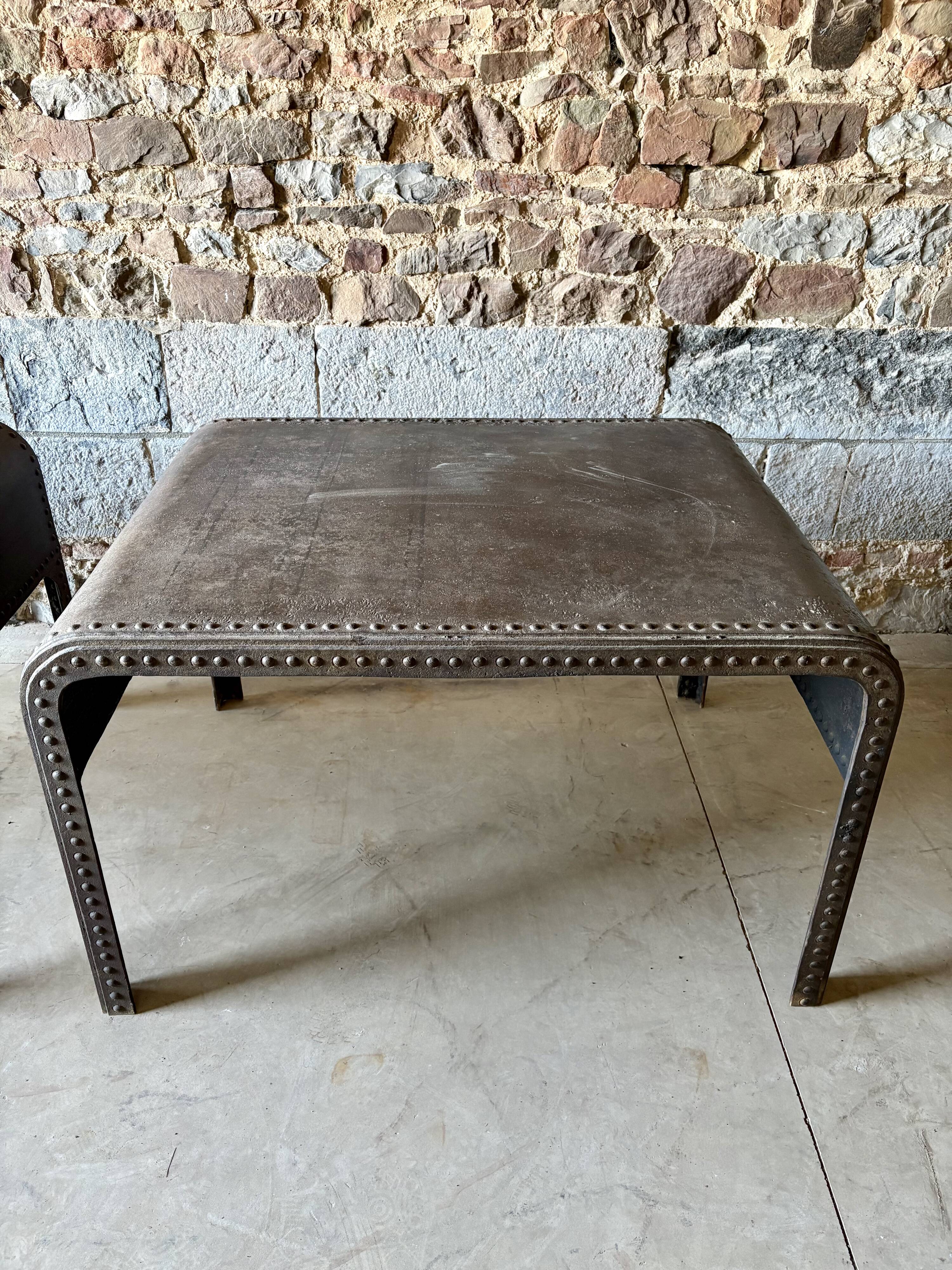Pair of large riveted metal industrial tables