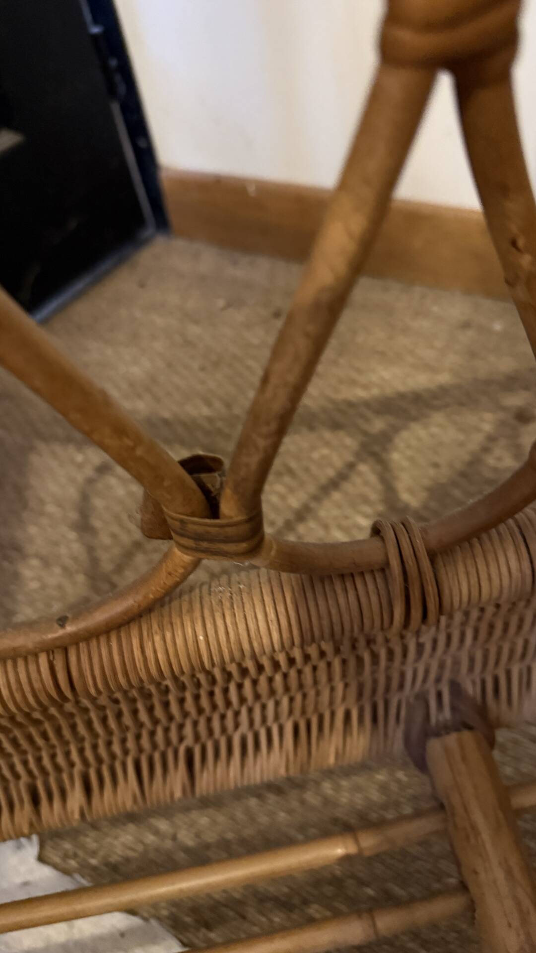 Vintage rattan baby cot on wheels.