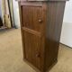 Old small storage unit with sliding and hinged doors.
