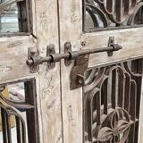 Chiseled teak door with openwork wrought iron panels