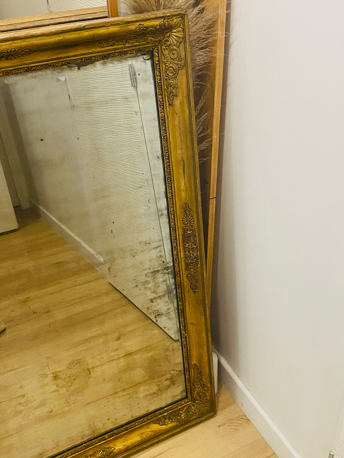 Antique mercury mirror with an Empire gold frame.