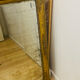 Antique mercury mirror with an Empire gold frame.