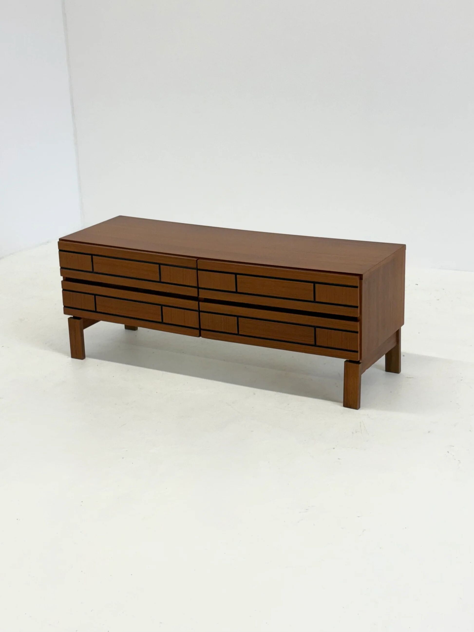 Buffet bas en bois italien avec des lignes noires graphiques.