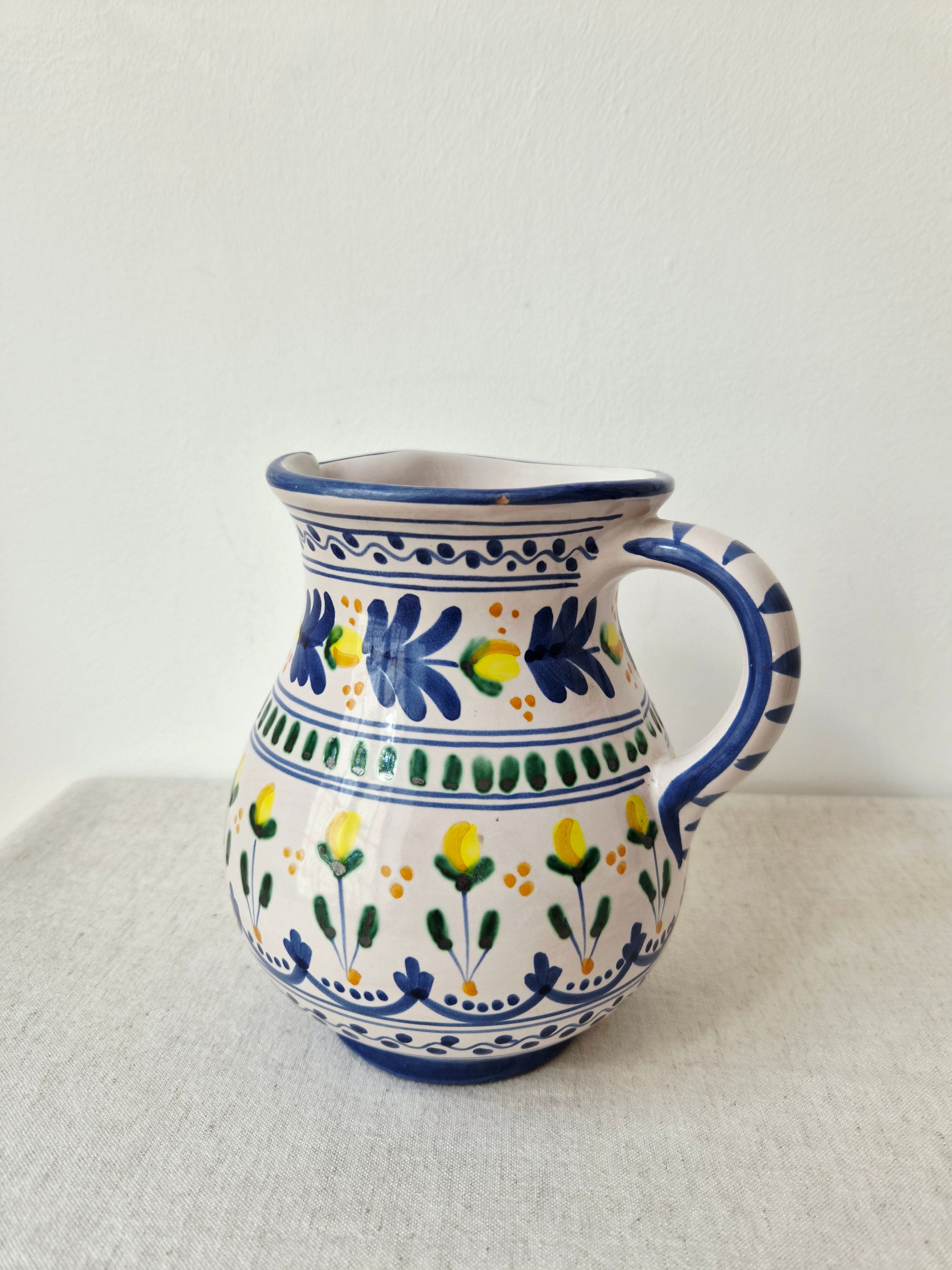 Vintage ceramic pitcher/vase hand-painted with floral decoration.