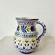 Vintage ceramic pitcher/vase hand-painted with floral decoration.