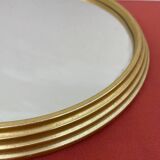 Round mirror in gold metal