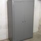 Curved wardrobe workshop locker made of wood repainted in grey.