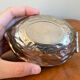 Silver metal nutcracker in the shape of a walnut